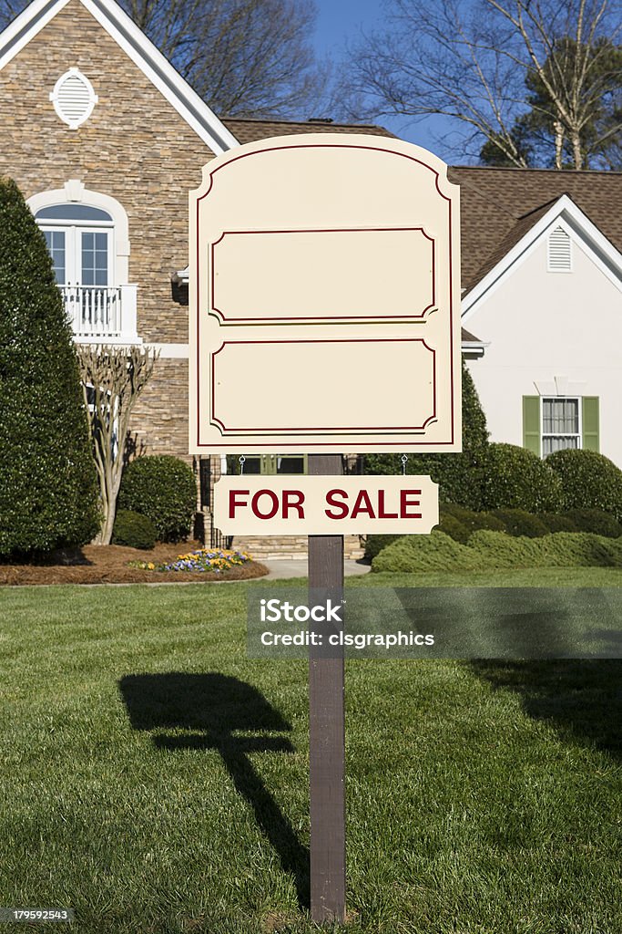 For Sale sign in front of a home A blank for sale real estate sign in fron of a house for sale Blank Stock Photo