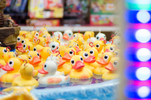 A lot of ducklings in a fairground attraction.