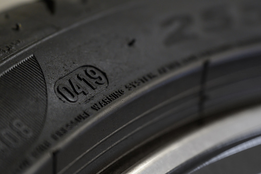 Extreme close up of the production week and year marking on a tire sidewall.