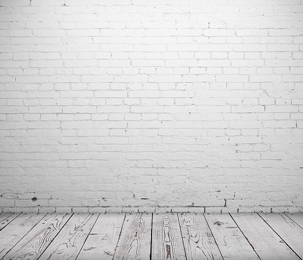 istock Grey wooden floor with white brick wall 179600309
