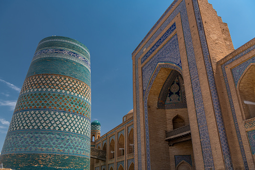 Kalta minaret left, muhammad amin khan madrasah to the right, ichon qala, Khiva, Uzbekistan. Close up image