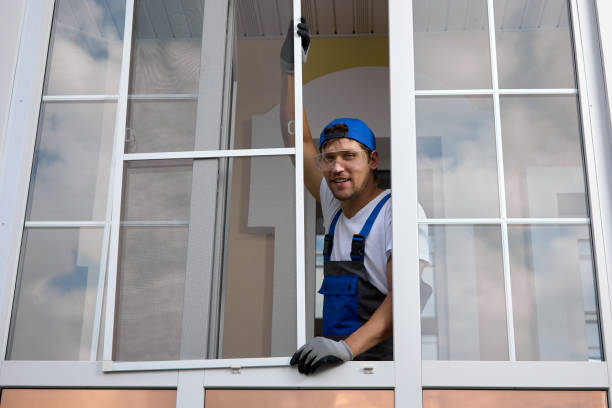 istock Worker smiles camera, holds mosquito net on plastic window with his hands 1796016242