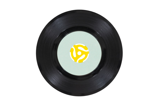 Vintage 45 rpm vinyl record with yellow adapter.