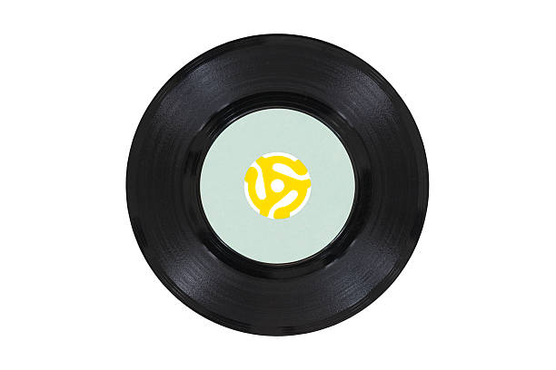 Vintage Vinyl Disk with Yellow Adapter Vintage 45 rpm vinyl record with yellow adapter. plug adapter stock pictures, royalty-free photos & images