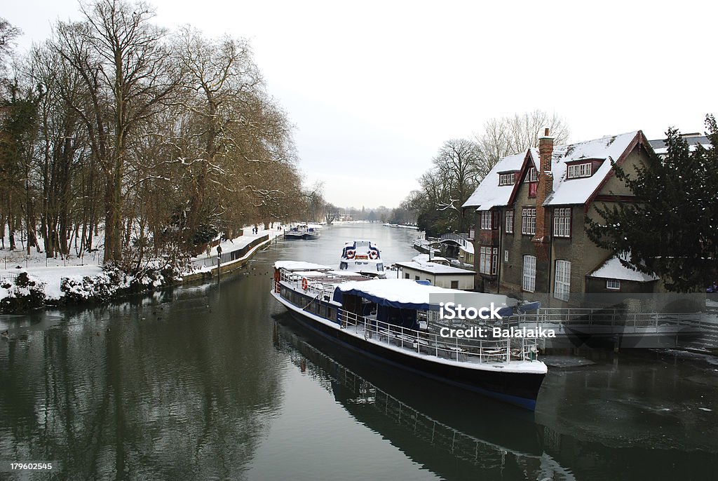 Boat on Thames River Boat covered in snow on Thames River, Oxford, England Building Exterior Stock Photo