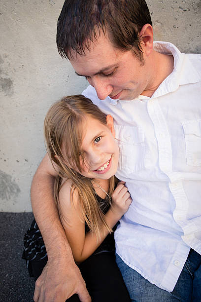 Happy Father and Daughter Cuddling Outside