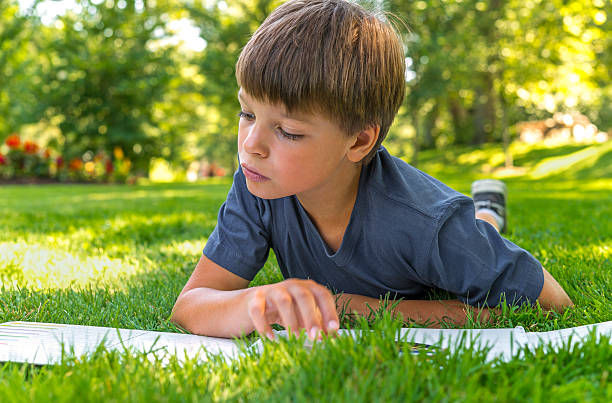 istock Closeup of boy reading a book 179603555