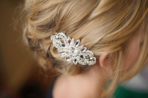 A closeup of a diamond hair piece in a bride's hair.