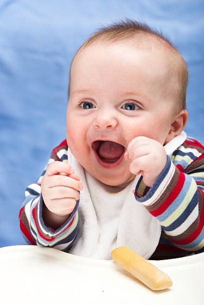 Very happy, messy 6 months old boy stock photo