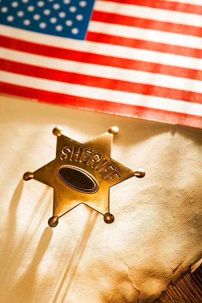 istock Sheriff star and United States flag on old document 179606163