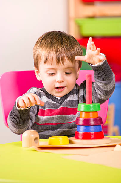 istock Young boy plays with wooden stacking blocks 179607702