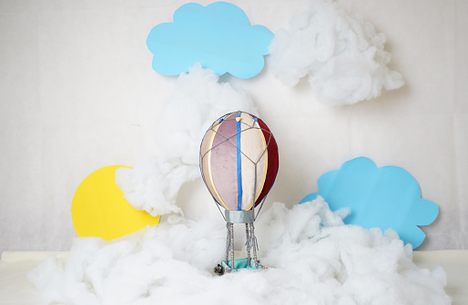 the decoration is a small multicolored balloon in white clouds and blue sky