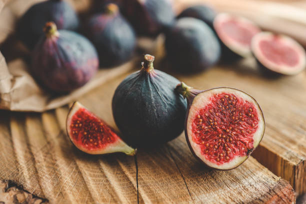 istock A few figs in a bowl on an old wooden background. 1796078337