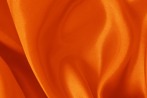 Orange fabric cloth texture for background and design art work, beautiful crumpled pattern of silk or linen.