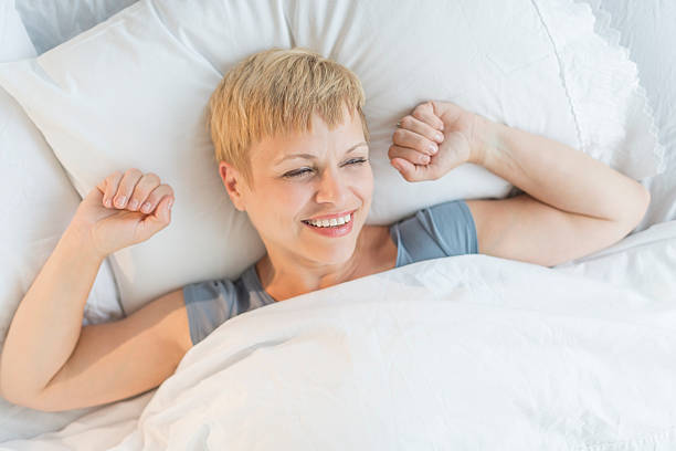 istock Happy Woman Waking Up In Bed 179611322