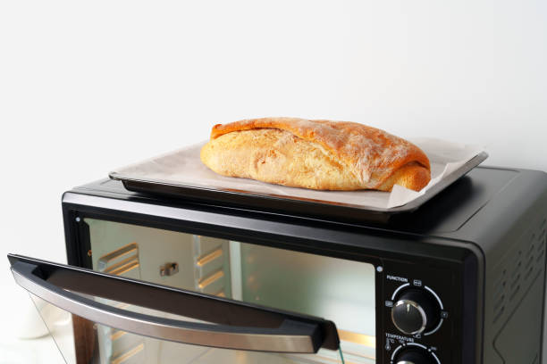 istock Freshly baked bread in mini oven in the kitchen 1796118210