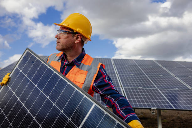 Professional electrician mounting solar module. stock photo