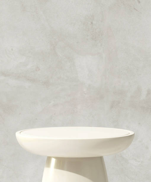istock White round glossy podium table in sunlight on gray polished cement wall 1796140758