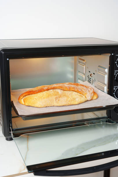 istock Freshly baked bread in mini oven in the kitchen 1796150151