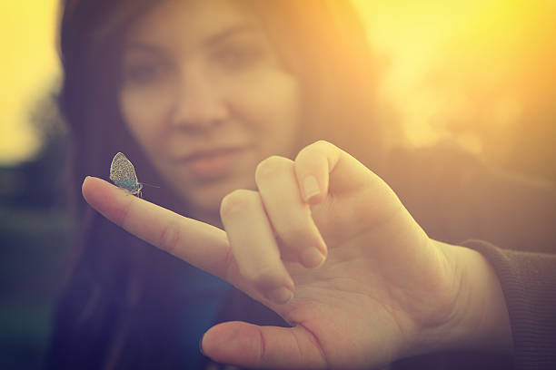 istock Butterfly on young woman finger 179615568