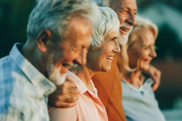istock Happy senior friends walking embraced in nature. 1796161798