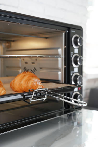 istock Modern mini electric oven with freshly baked croissants in kitchen 1796162833