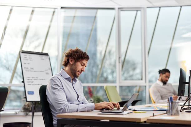 istock Young businessman working on laptop in the office. 1796172903