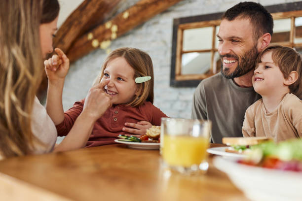 istock Happy family having fun during breakfast at dining table. 1796175489