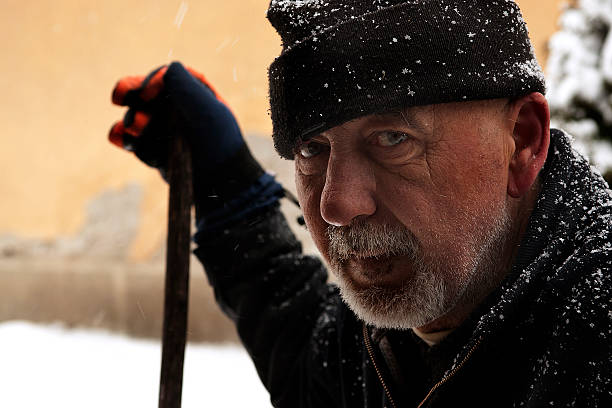 istock Close up of tired snow shoveling man 179617830