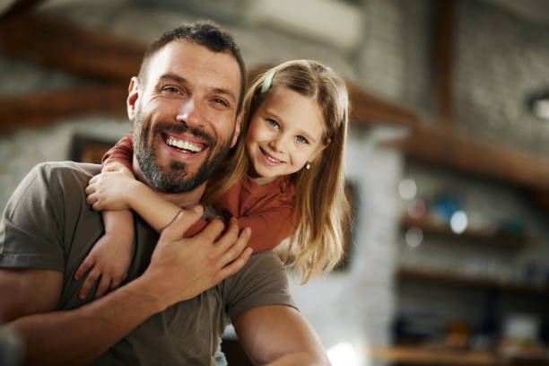 istock Happy single father and daughter embracing at home. 1796179718