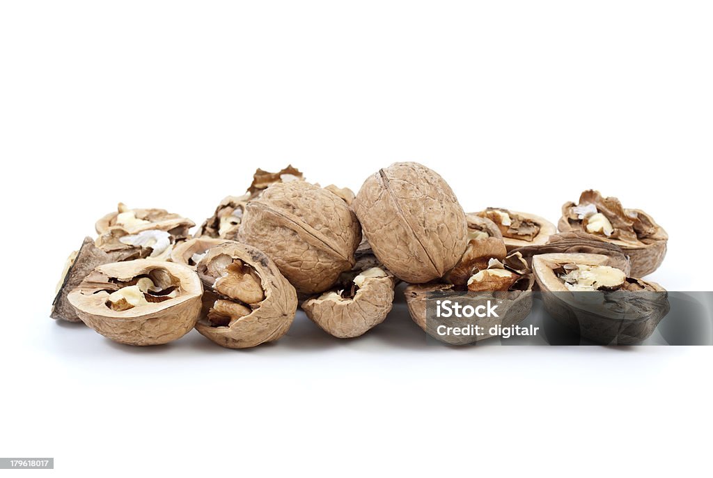 Cracked and whole walnuts Cracked and whole walnuts isolated on the white background Brown Stock Photo