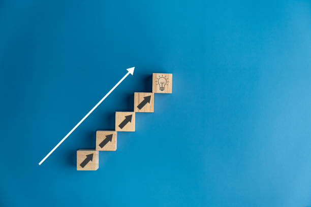 istock Stair wooden blocks bright light bulb arrows up, ideas, creativity, thoughts, knowledge, education, imagination, new things, research. 1796181840