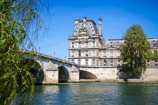 Louvre museum and Royal bridge view from the Seine river banks, Paris, France