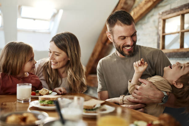istock Young happy family talking during breakfast at dining table. 1796188391