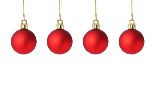Close-up of hanging four red Christmas ornaments against white background.