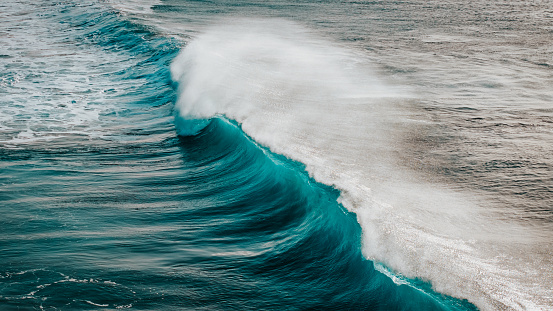 Giant Breaking Wave of the Atlantic Ocean on the North-Western Coast of Fuerteventura. Famous Surf and Windsurfing Spot of El Cotillo Beach. Aerial Drone Point of View Breaking Waves Detail. Turquoise - Blue Transparent Aerial Ocean Wave Detail. El Cotillo Beach, Fuerteventura Island, Canary Islands, Spain - Africa