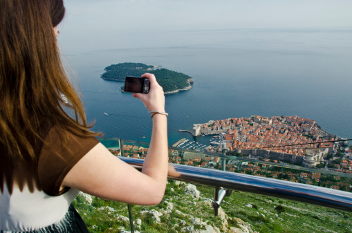 Tourist taking pictures of Dubrovnik, Croatia