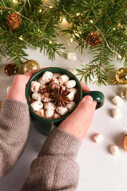 istock Christmas time.Hot chocolate with marshmallows in children's hands 1796231600