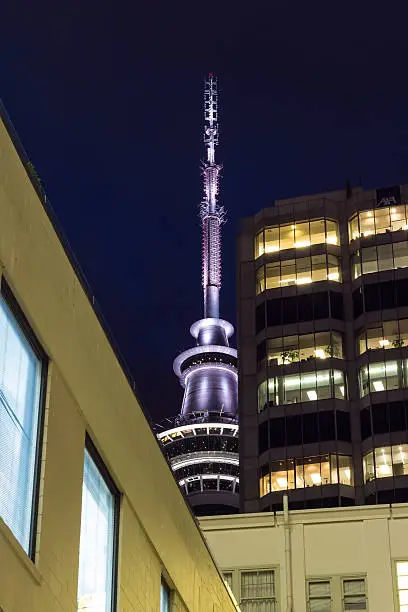 Auckland's Skytower looming in the background, behind some tall buildings in Auckland, New Zealand