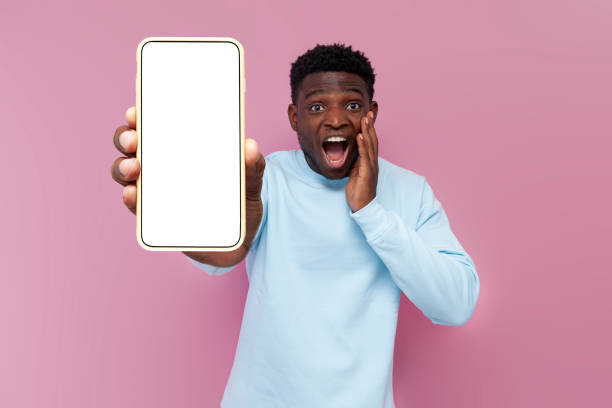 istock shocked african american man in blue sweater showing empty smartphone screen and being surprised 1796245964