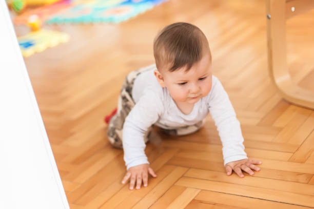 istock Cute baby boy crawls on the home floor. Front view 1796269103