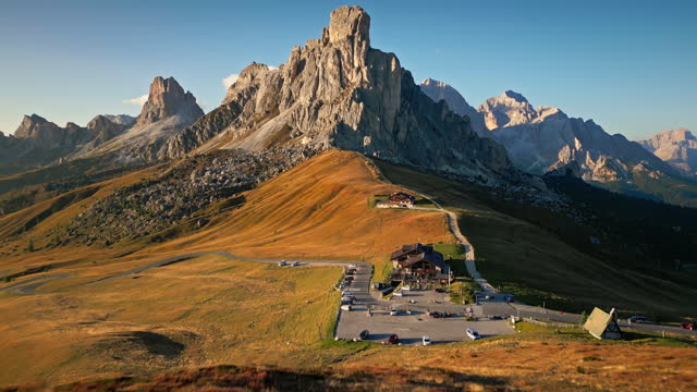 Aerial view Real time Footage of The Giau Pass at the sunset time, one of the most famous in the Dolomites Alps, Italy,