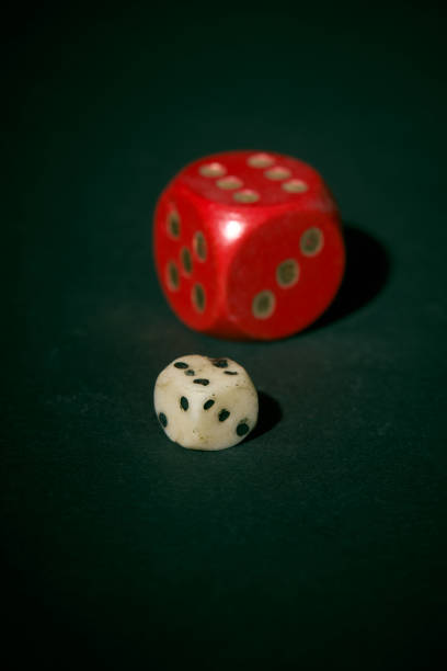 istock Red and small white dice on dark green background 1796283002