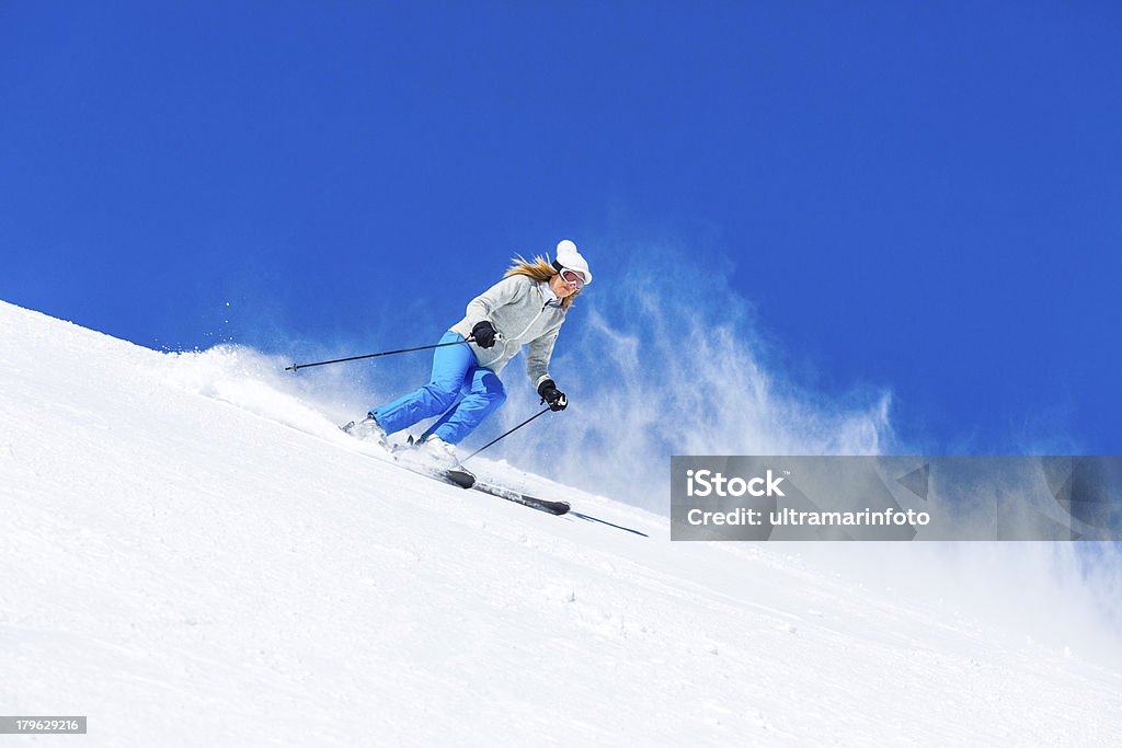 Donne di età media neve sciatore sci sulla soleggiata ski Resort - Foto stock royalty-free di Neve
