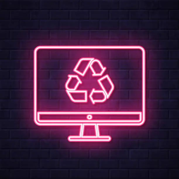 Vector illustration of Desktop computer with recycle symbol. Glowing neon icon on brick wall background