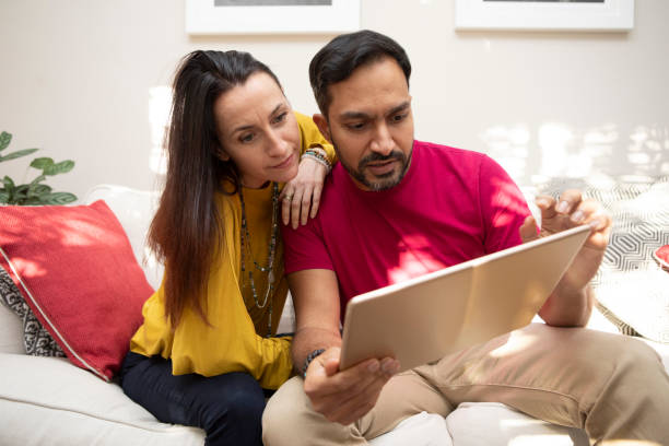 istock Male and female couple on a sofa using a digital tablet 1796293980