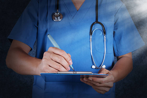 istock medical doctor with stethoscope writing 179629483