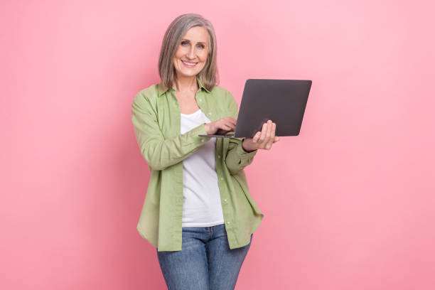 istock Photo of retired coder woman try understand learning prompts ai generations content maker using laptop isolated on pink color background 1796315735
