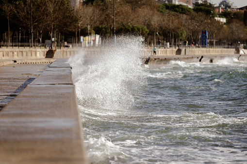 Sea waves splash on the coastline.