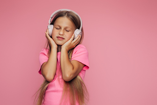 Cute emotional teenager girl listening to music